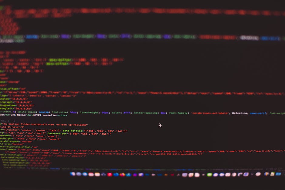 A close-up view of a computer screen displaying lines of colorful code with syntax highlighting, including various programming keywords and functions in shades of green, pink, blue, and yellow. The sc
